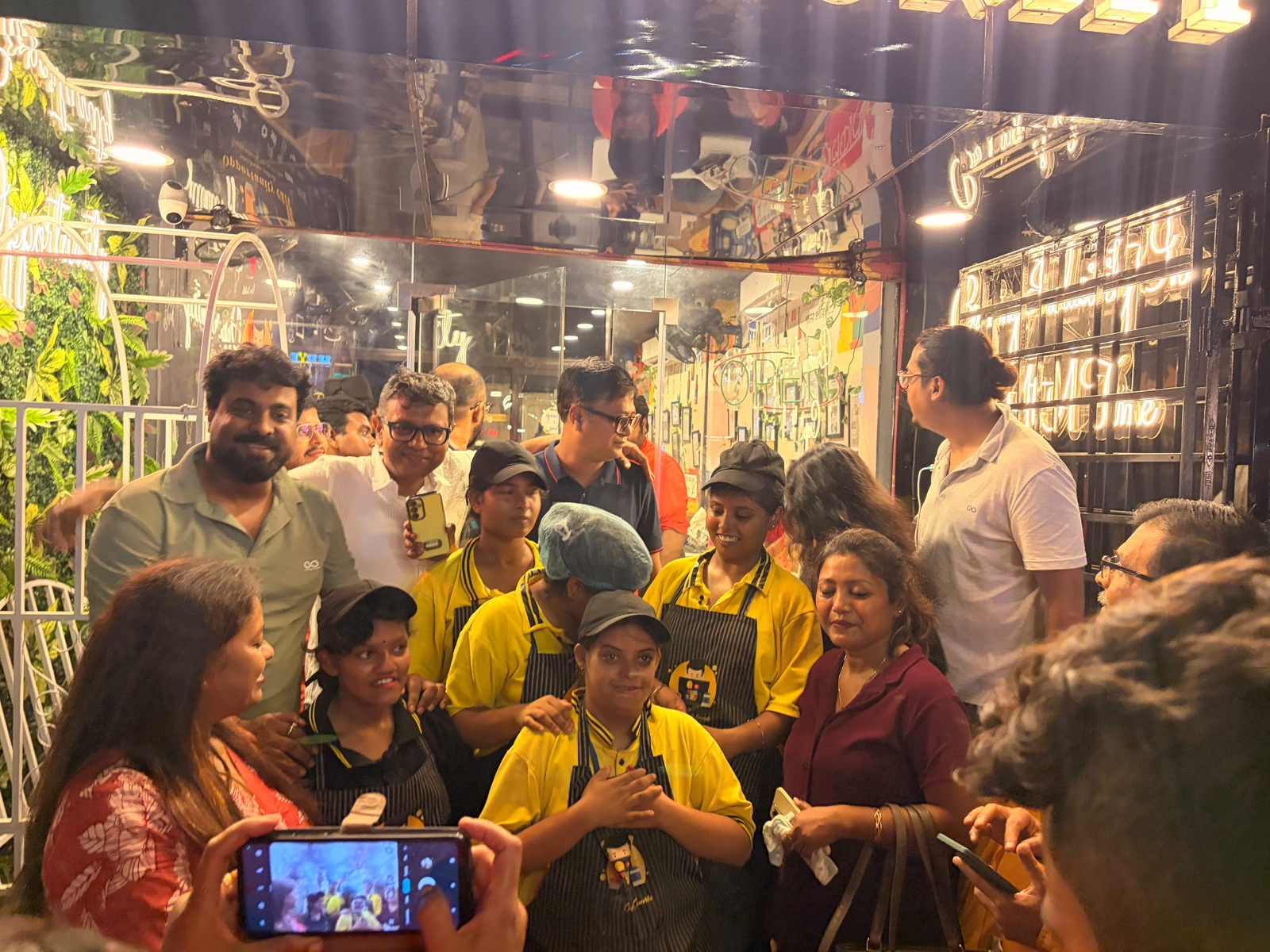 Cafe staff and visitors gathered inside Opportunity Cafe on opening night