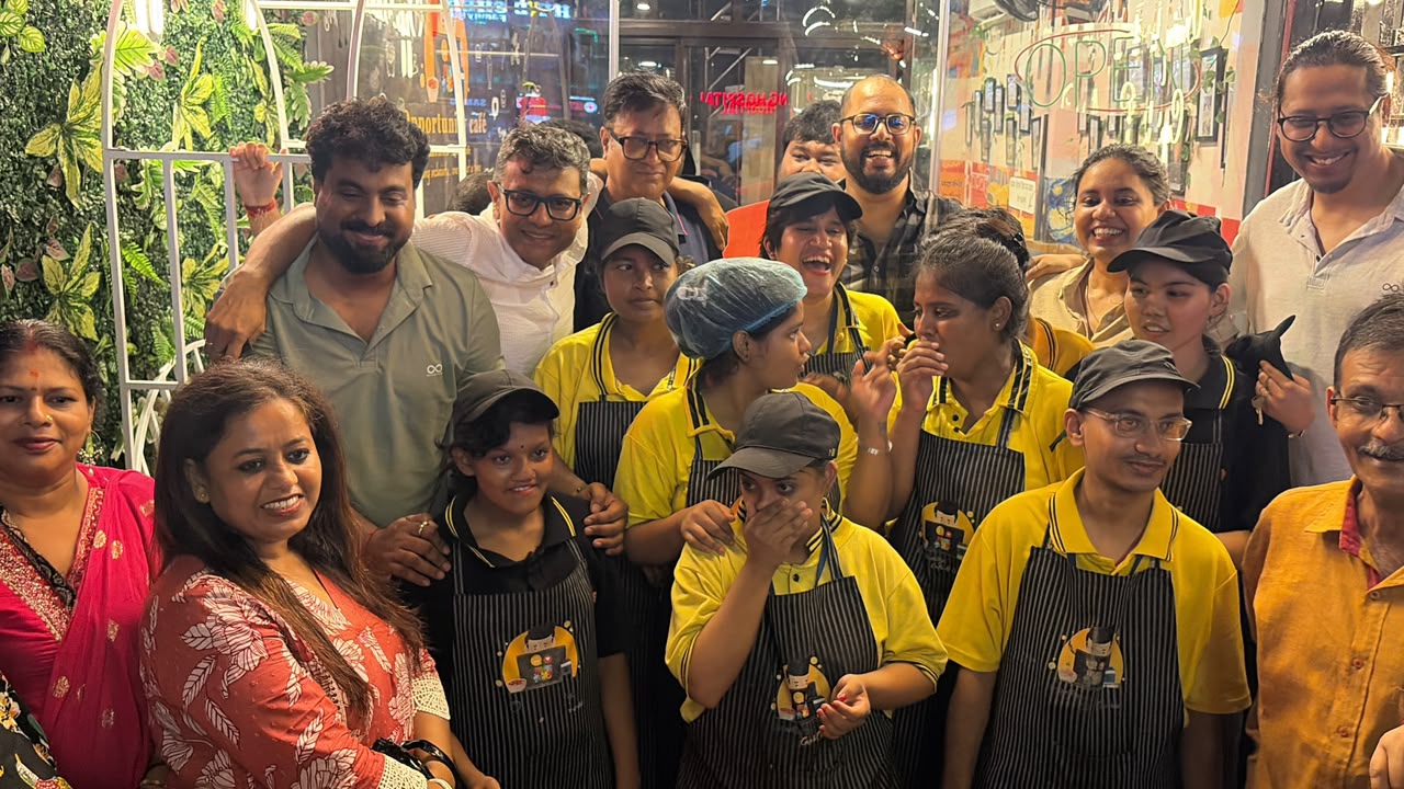 Opportunity Cafe team members in uniform with supporters